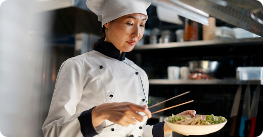 Chef Olivia Sterling thoughtfully planning a menu in a professional kitchen.