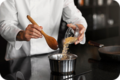Chef Olivia Sterling skillfully demonstrating a cooking technique.
