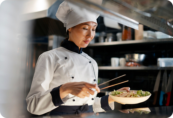 Chef Olivia Sterling professionally plating a gourmet dish.