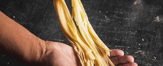Fresh pasta being skillfully handmade during an interactive cooking class with Chef Olivia Sterling. 