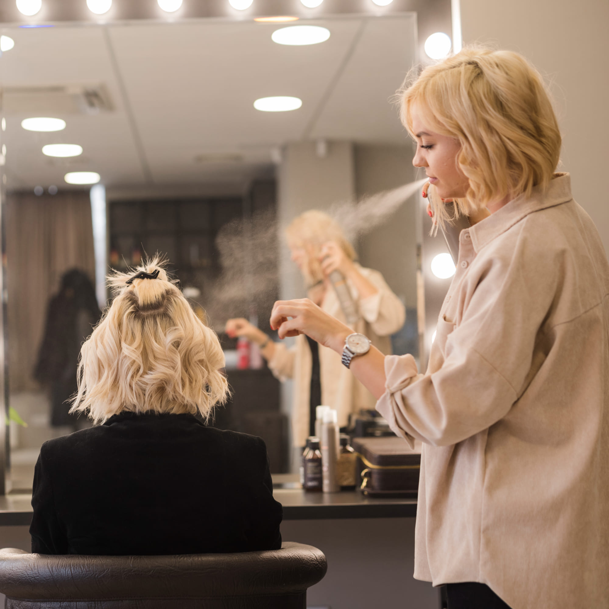 Hair stylist providing a salon service to a client