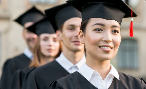Group of diverse international students celebrating graduation day.